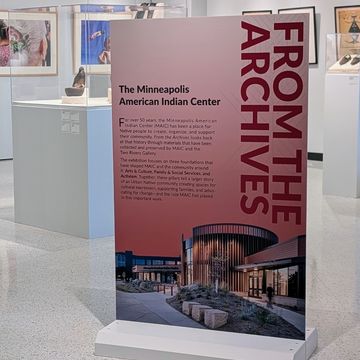 White-painted sign base with a From the Archives panel in the Two Rivers Gallery