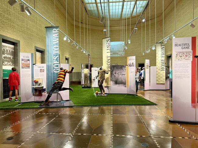 The Beautiful Game and the Great War exhibit with football mannequins on a turf field