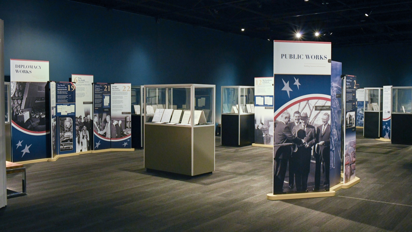 Ike's Work exhibit at the Eisenhower Presidential Library, with red, white, and blue panel towers and document cases