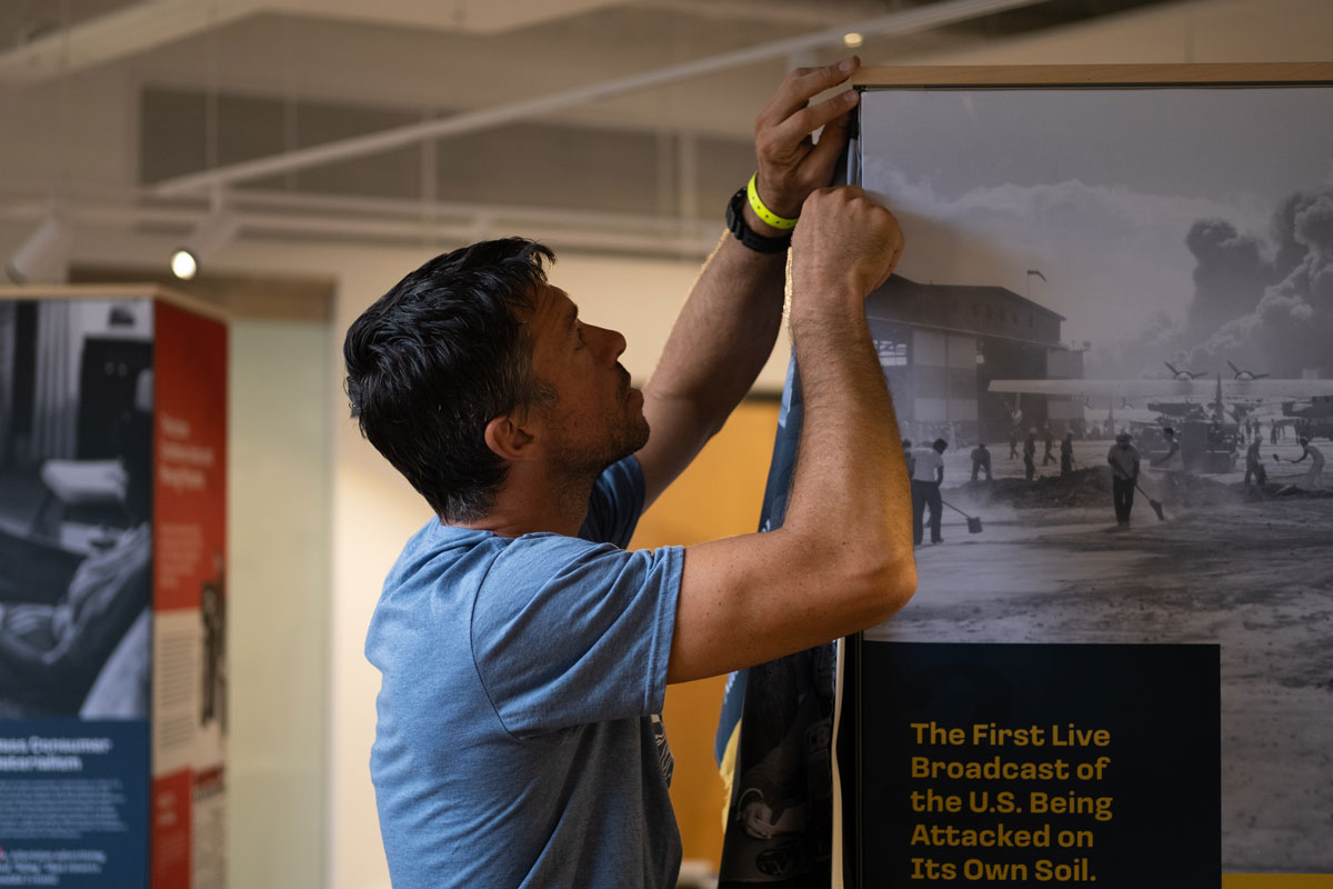 Graham Unruh interacting with the digital touchscreens on the exhibit columns.