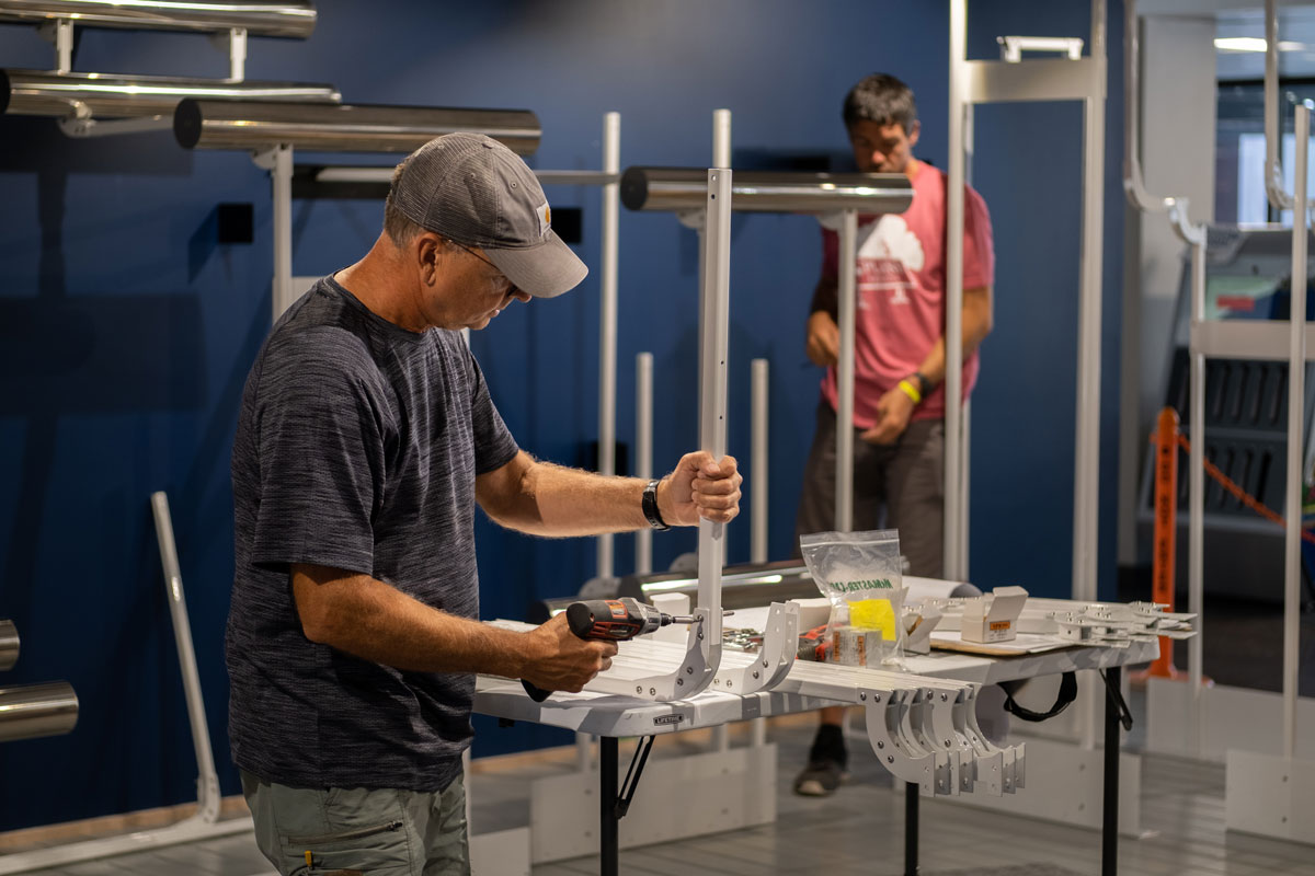 Graham Unruh interacting with the digital touchscreens on the exhibit columns.